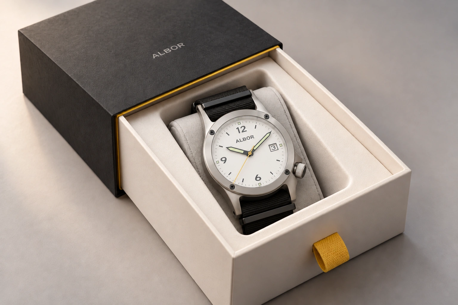 First Light concept: black outer sleeve and warm-white sliding drawer with a fine yellow opening edge with the current integrated-lug ALBOR watch